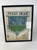 Framed vintage sheet music "Peggy Dear" showing cover design and water damage