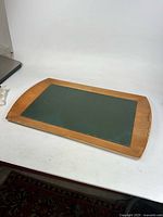 Overall view of wooden tray with leather top