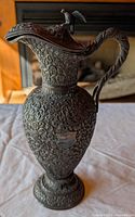 Full view of ornate metal pitcher showing design and form