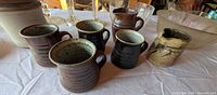 Group shot showing all pottery pieces, mugs, bowls, jug, and glass items
