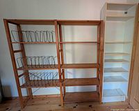 Wood shelving unit with wire dividers beside tall white bookshelf