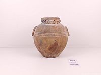 Front view of globular pottery jar with handles and braided rim