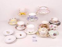 All 39 pieces grouped: assorted teacups with matching saucers and extra white saucers