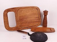 Overall lot showing pan, cutting board, serving tray, grinder
