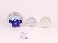 All three glass paperweights side by side