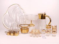 Entire 26-piece gold-trimmed glassware set displayed together
