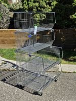 Full view of chrome wire stacking shelf unit showing four baskets and wheels