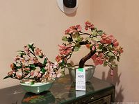 Both gemstone bonsai trees on cabinet