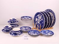 Full set of Blue Willow dinnerware displayed