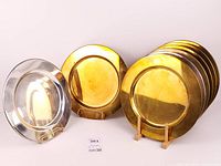 Mixed view showing both brass and glass charger sets