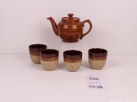 front view of teapot and four cups