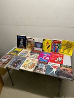 Overview of all comics and books laid out on table