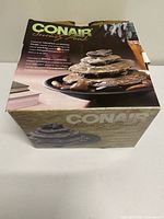 Retail box front showing Conair Serenity Pond branding and image of fountain