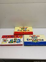 Three boxed puzzle sets laid out together