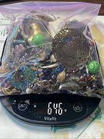 Bagged lot of mixed costume jewelry on scale reading 646 g