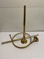 Both brass horns on table to show overall forms