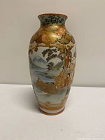 Front view showing landscape with Mount Fuji, warrior figures and gilt detailing