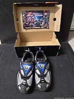 Pair of sneakers in open original box, hang tag visible