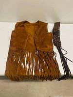 Front of brown suede fringe vest and matching studded belt