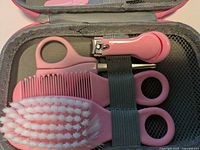 close-up of lower compartment with brush, comb, scissors, clippers