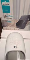 Shiatsu massage cushion box beside QNQZE hand massager