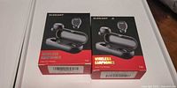 Front view of two sealed ELEGIANT T40 wireless earphones retail boxes