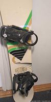 Full view of Rossignol Imperial snowboard with mounted Burton bindings
