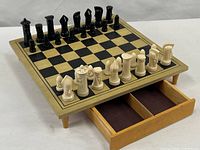 Full view of chess board on legs, drawer open, pieces set