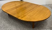 Low oval table shown with both leaves installed