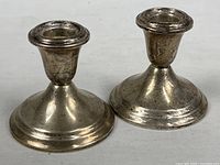 Front view of both sterling candle holders