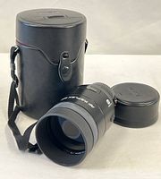 Lens with cap and storage case