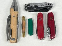 All six pocket tools arranged closed for size comparison