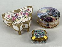 Group view of three porcelain boxes showing sizes and shapes