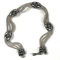 Full view of sterling silver bracelet showing multi-strand chains and decorative panels