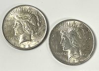 Obverse sides of two 1922 Peace Dollars showing Liberty profile and 1922 date