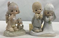 Both Precious Moments figurines side by side