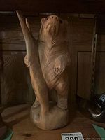 Front view of wooden bear sculpture showing overall form and height