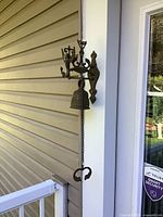 Bell on exterior wall showing full mounting and chain