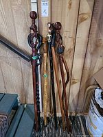 Group of seven canes leaning against wall