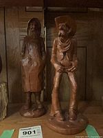 Both wood figurines on shelf