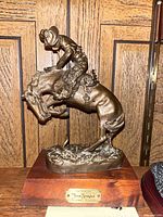 Front view of cast iron Remington Rattlesnake sculpture on wood base