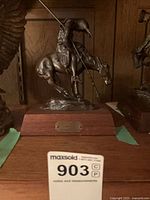 Front view of End of the Trail cast figure on wood base with lot tag visible