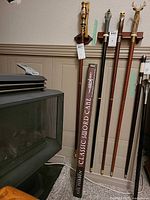 Full view of boxed Classic Sword Cane leaning against wall