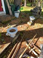 Two white concrete urn planters on stone steps