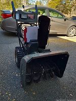 Full front view showing auger housing, chute, overall wear