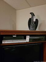 Shelf view showing Sears VCR, Koss DVD player beneath Bell receiver