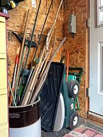 Step2 cart, crock with stakes, long-handled rake visible