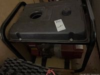 Full view of generator in frame showing black fuel tank and frame