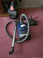 Overall view of vacuum, hose, wand, powerhead and accessories