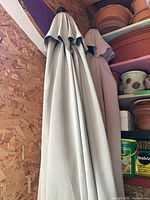 Two closed umbrellas hanging, showing fabric canopies